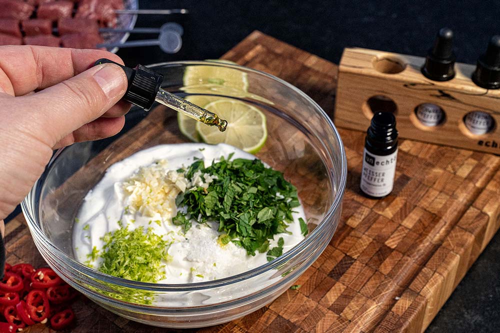 Wir geben die Minze zusammen mit dem Knoblauch in den Joghurt und fügen noch etwas Abrieb der Limette hinzu. 
                    Nun würzen wir alles mit Meersalz und Pfeffer. Zuletzt geben wir noch den Saft der Limette hinzu.