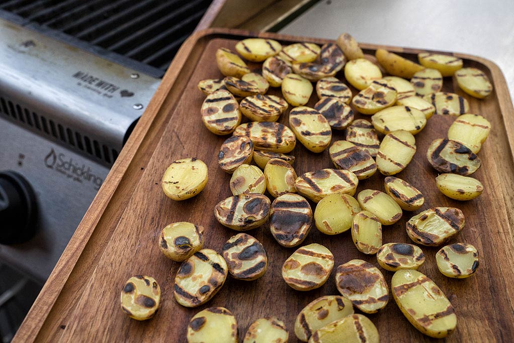 Grill auf direkte Hitze vorheizen. Die Kartoffeln mit Schnittfläche nach unten für wenige Sekunden auf heißen Grillrost legen.