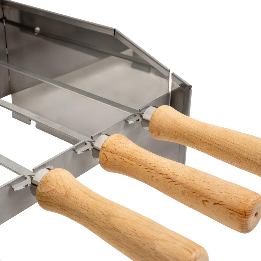 Die Grillspieße lagern dank der Aussparungen sicher auf dem Spritzschutz